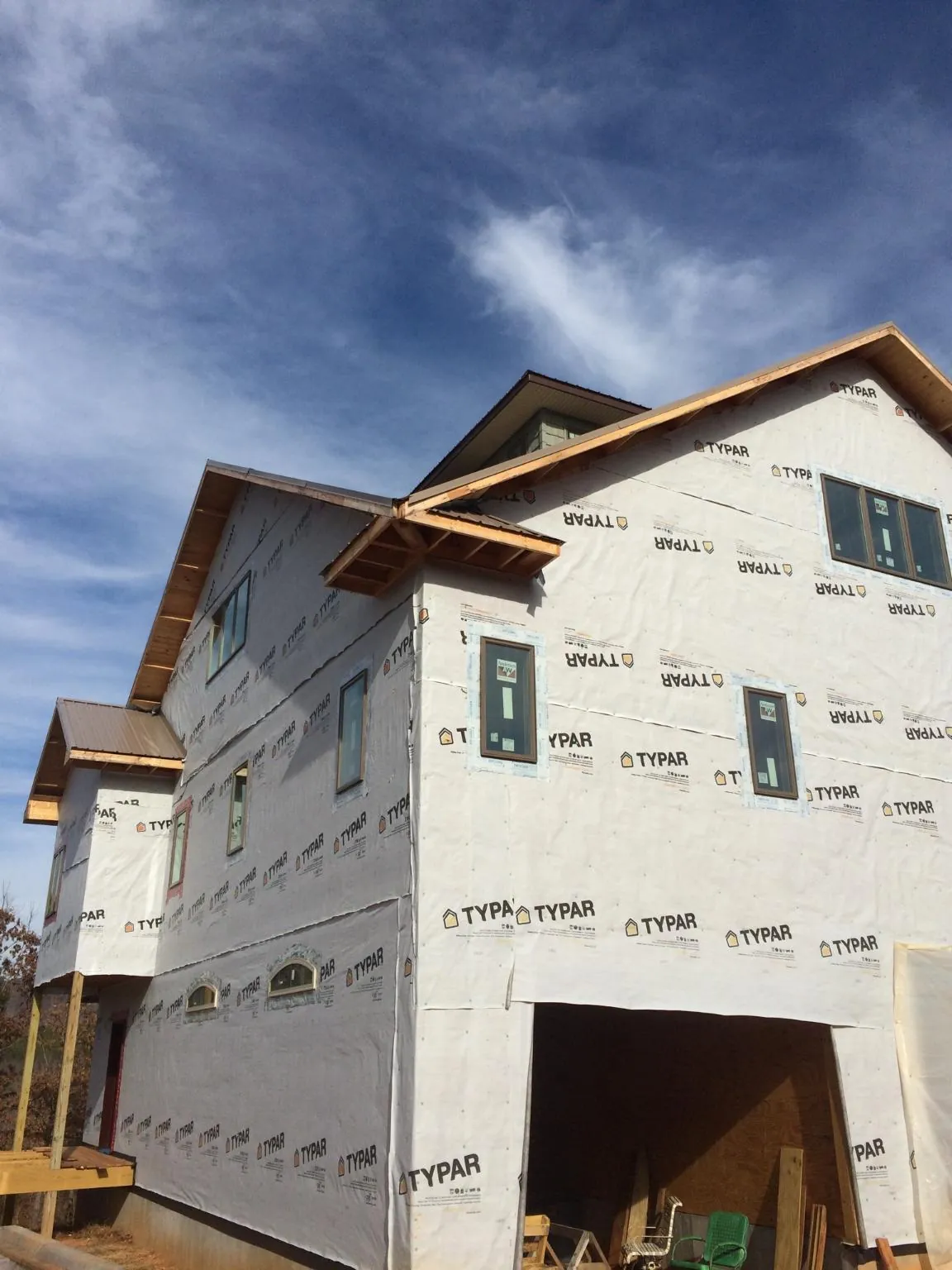 Stick built house wrapped in Typar with new roof framing and dormers in Clayton